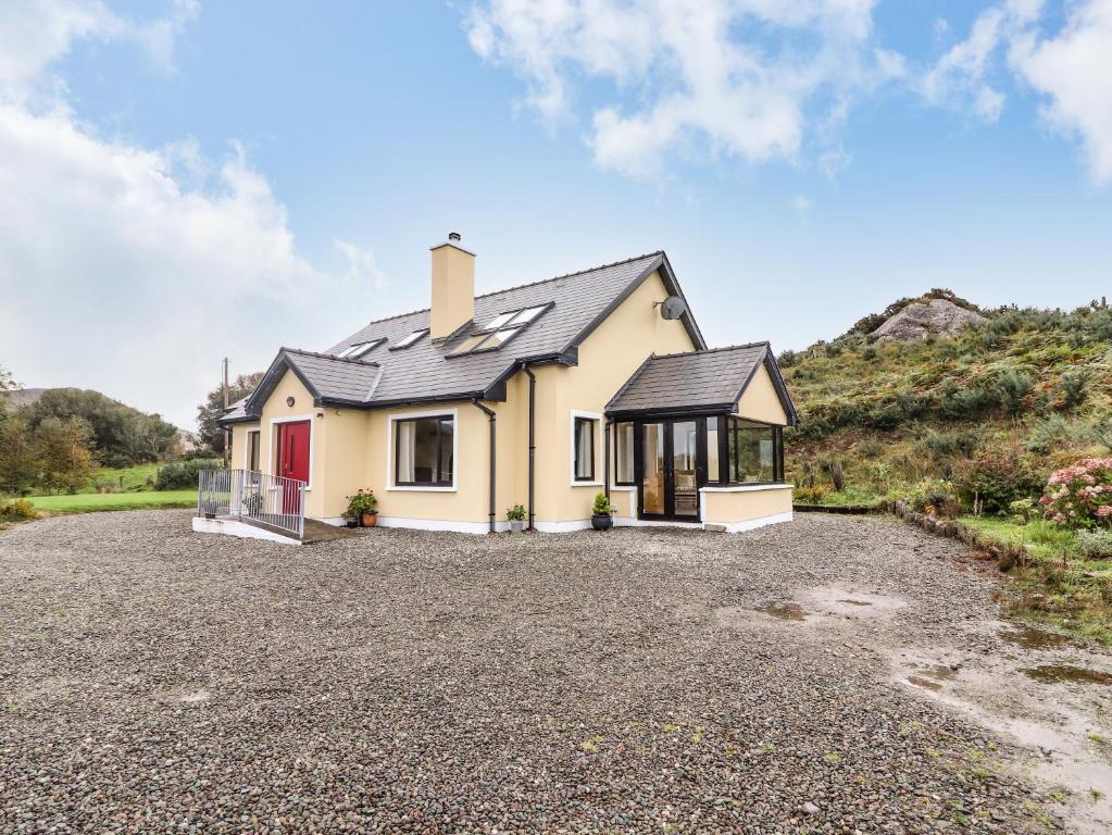 a house with a gravel driveway in front of it at Curraha in Kenmare