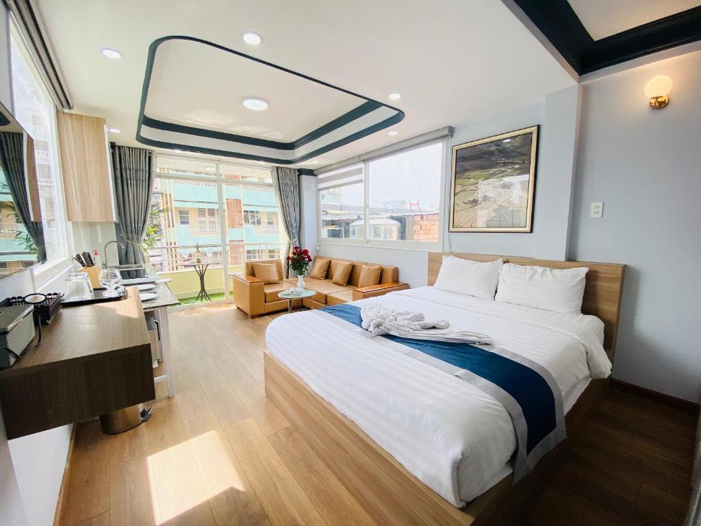 - une chambre avec un grand lit et un bureau dans l'établissement Home Away Homestay, City Center, D1, à Hô-Chi-Minh-Ville