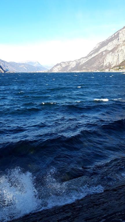 a large body of water with mountains in the background at Appartamento a Lecco sul Lago di Como in Lecco