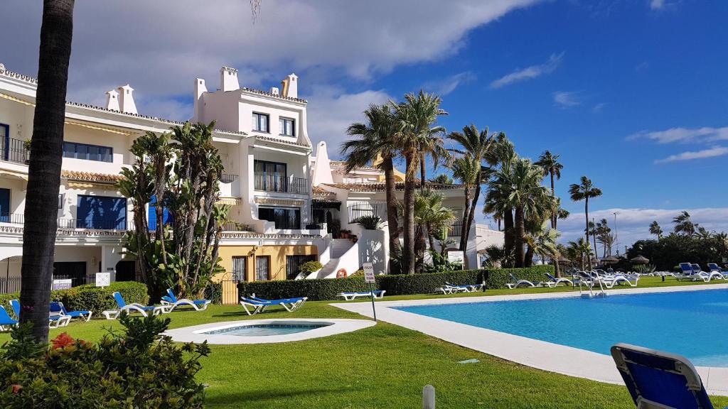 a resort with a swimming pool and a building at L157 Cabopino in Marbella