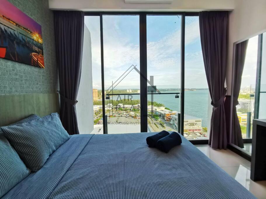 a bedroom with a bed with a view of the ocean at PD D’Wharf Amazing Seaview Suite 9 (Up to 6 Pax) in Port Dickson