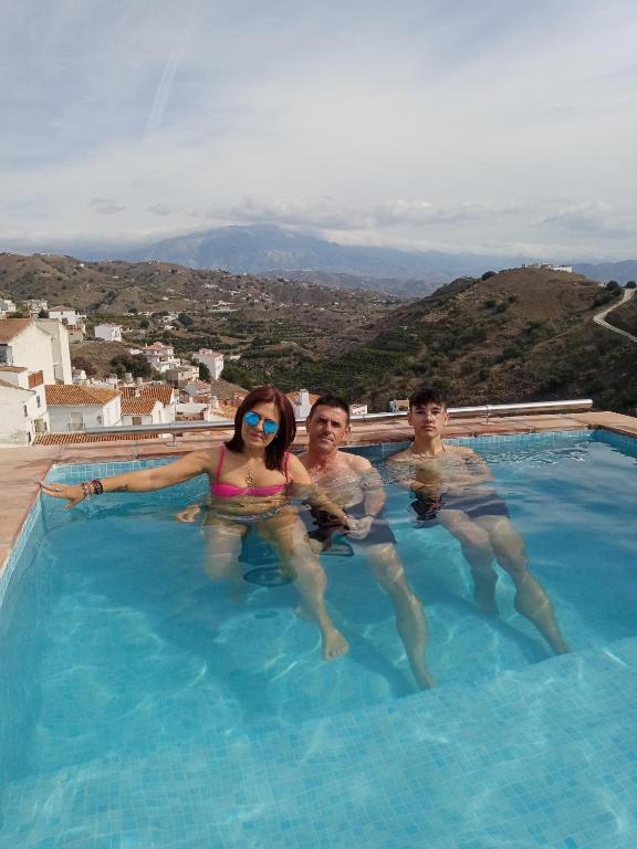 a group of people in a swimming pool at Casa de Luz in Almáchar