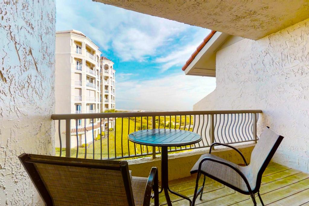 a balcony with a table and two chairs and a table at Hotel Side Condo at Amelia Island Plantation with Balcony, WiFi & Shared Pool in Fernandina Beach