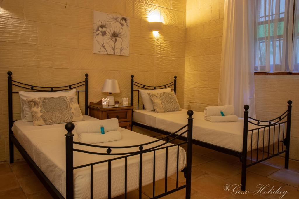 Letto o letti in una camera di Lellux Qala