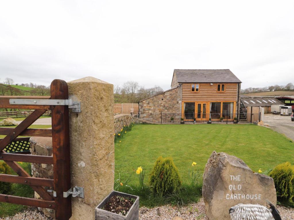 a gate in front of a house with a yard at The Old Cart House in Oswestry