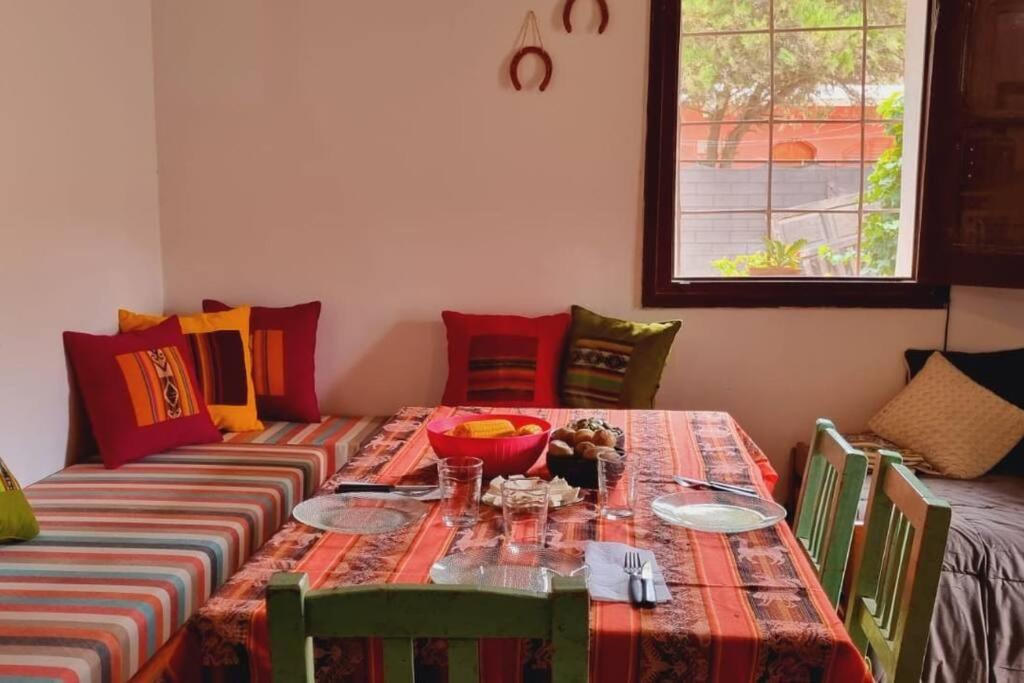 a dining room table with a bowl of food on it at Misky Kucho (dulce rincon) in Maimará