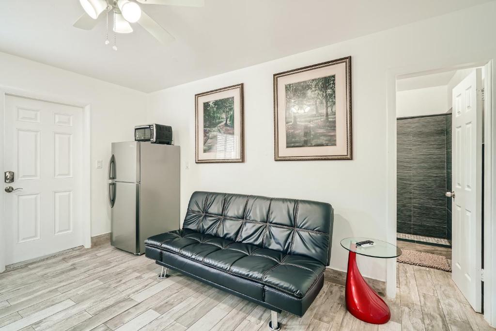 a black leather couch in a living room with a refrigerator at SII 1 Bedroom Tropical GEM! in West Palm Beach