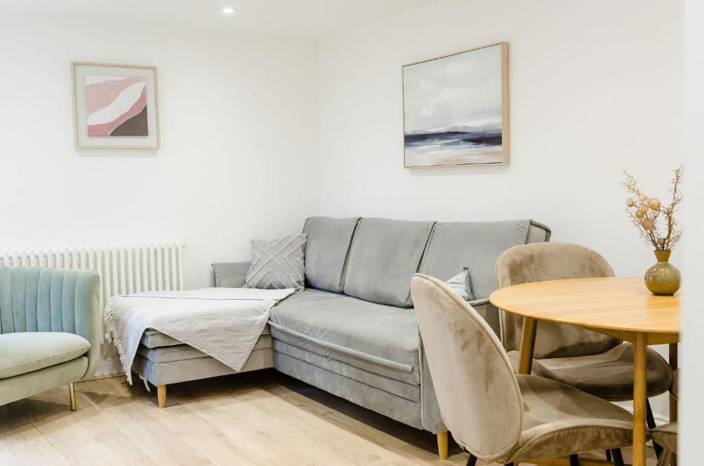 a living room with a couch and a table at Cozy Broadstairs Hideaway - 1 min walk to beach in Kent