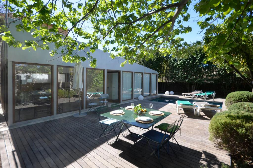 a patio with a table and chairs on a wooden deck at Els Llorers - Ref.050 in Begur