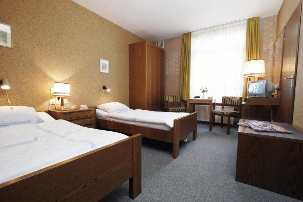 Postel nebo postele na pokoji v ubytování Hotel de Lindeboom