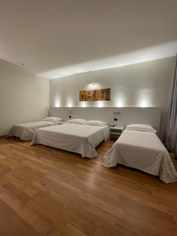 A bed or beds in a room at Albergo Ligabue