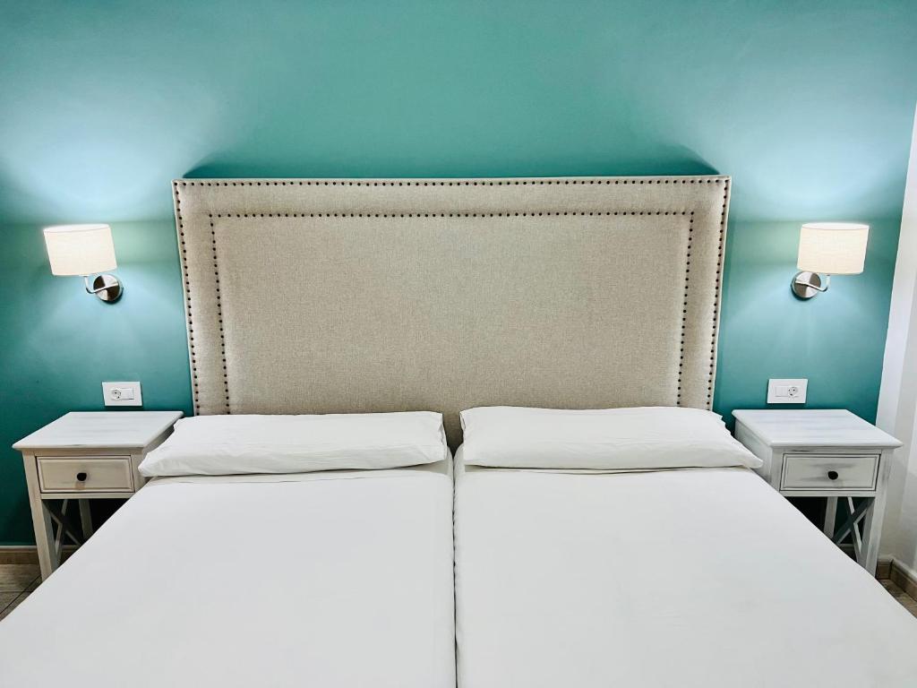 A bed or beds in a room at Apartamentos Frontera