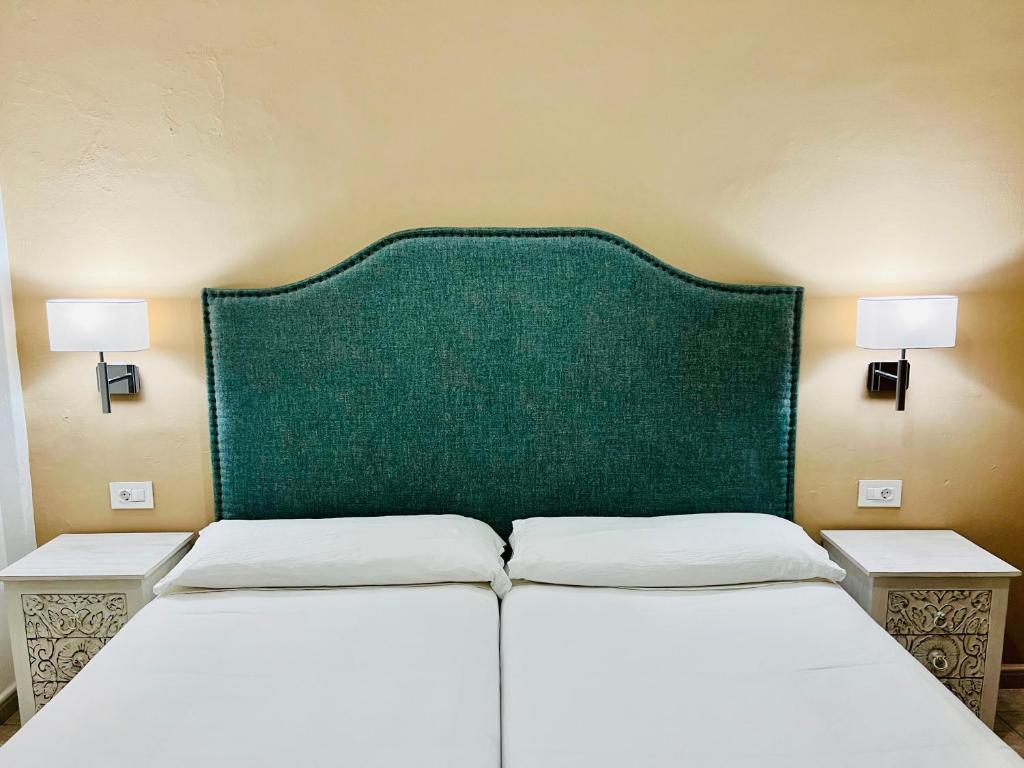 A bed or beds in a room at Apartamentos Frontera