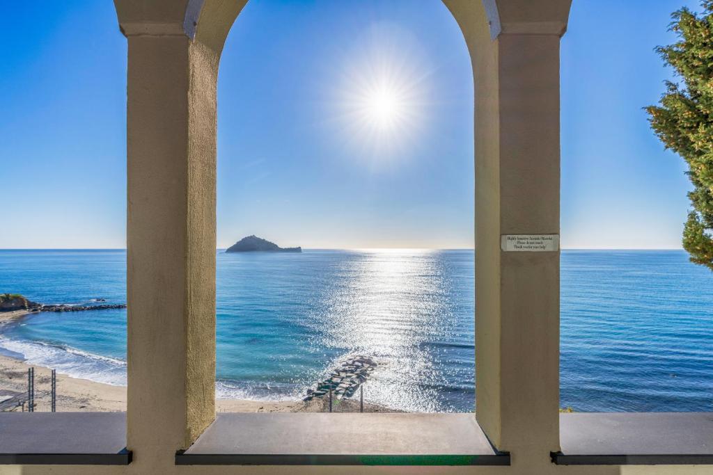 a view of the ocean through a window at Baba Residences in Alassio