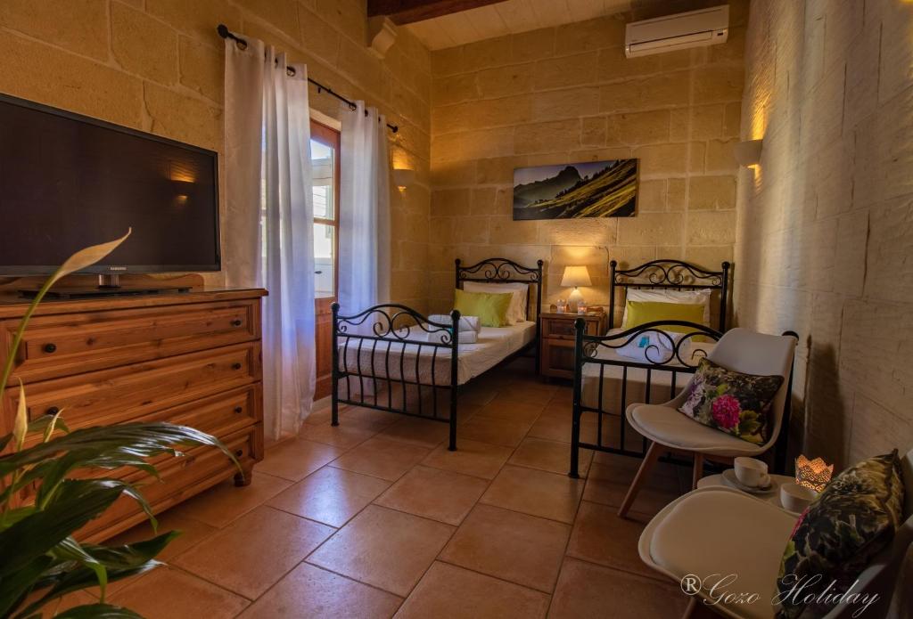 Letto o letti in una camera di Lellux Qala