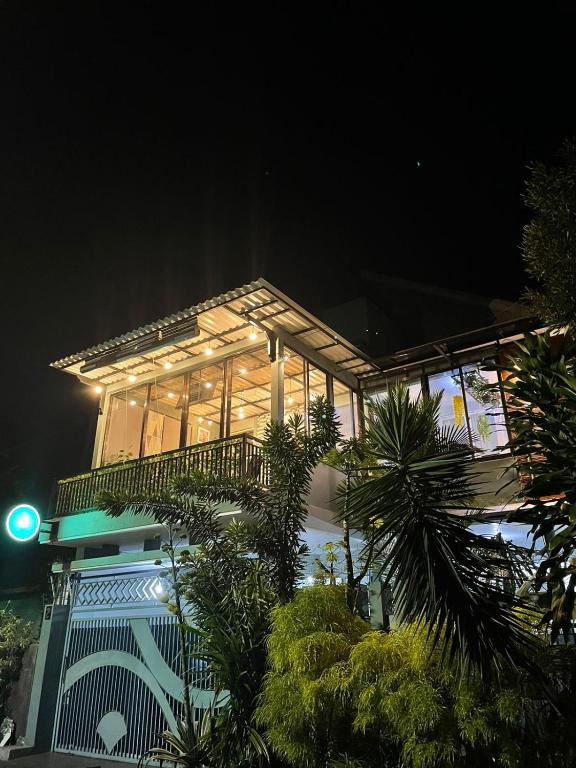 a large building with a lot of windows at night at The Safa Baiti Guest House Syariah in Rampal