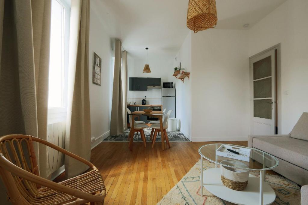 a living room with a couch and a table at The Timeless - Balzacien in Tours