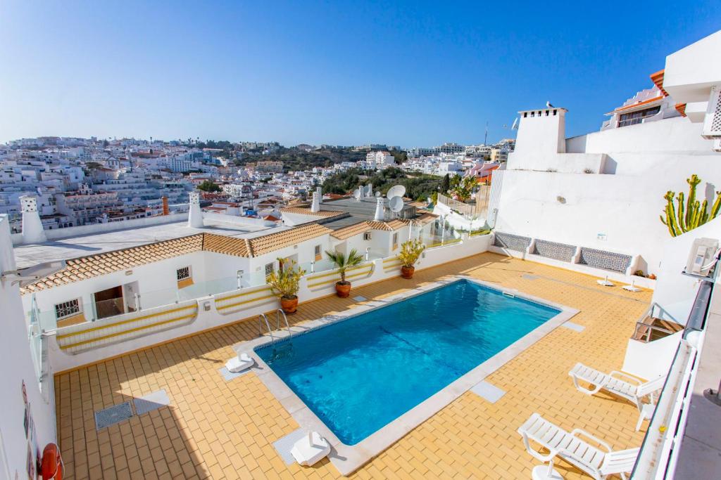 a pool on the roof of a house with a view at Clube do Monaco in Albufeira