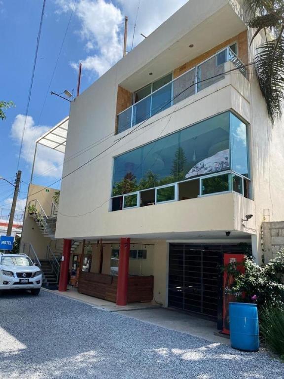 a building with a car parked in front of it at Hotel Sierra Inn in Xicotepec de Juárez