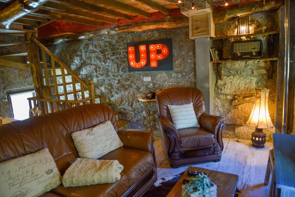 a living room with a couch and chairs in a house at Casa do Ti Gabriel in Sabugueiro