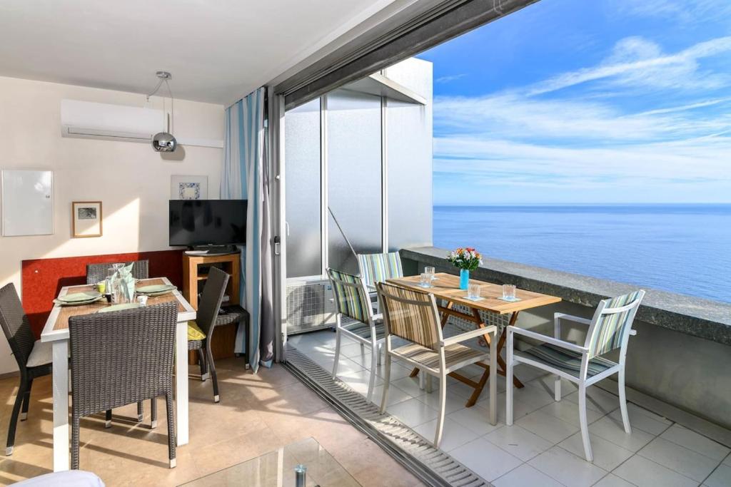 a dining room with a view of the ocean at Air-Conditioned Apartment With Sea View Furnished Terrace & Parking in Cap d'Ail