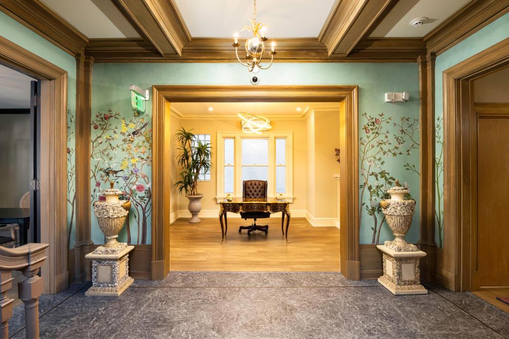 a hallway with a room with a table and vases at The Edward Buffalo in Buffalo