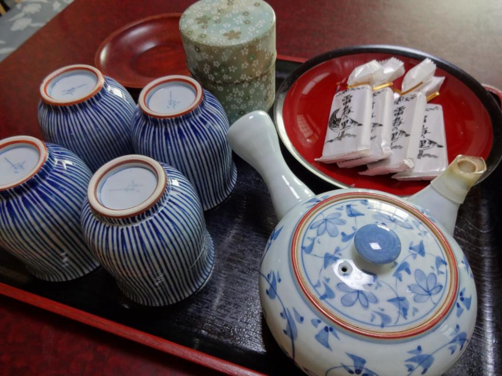 a group of blue and white vases on a table at Jizokan Matsuya Ryokan in Nagano
