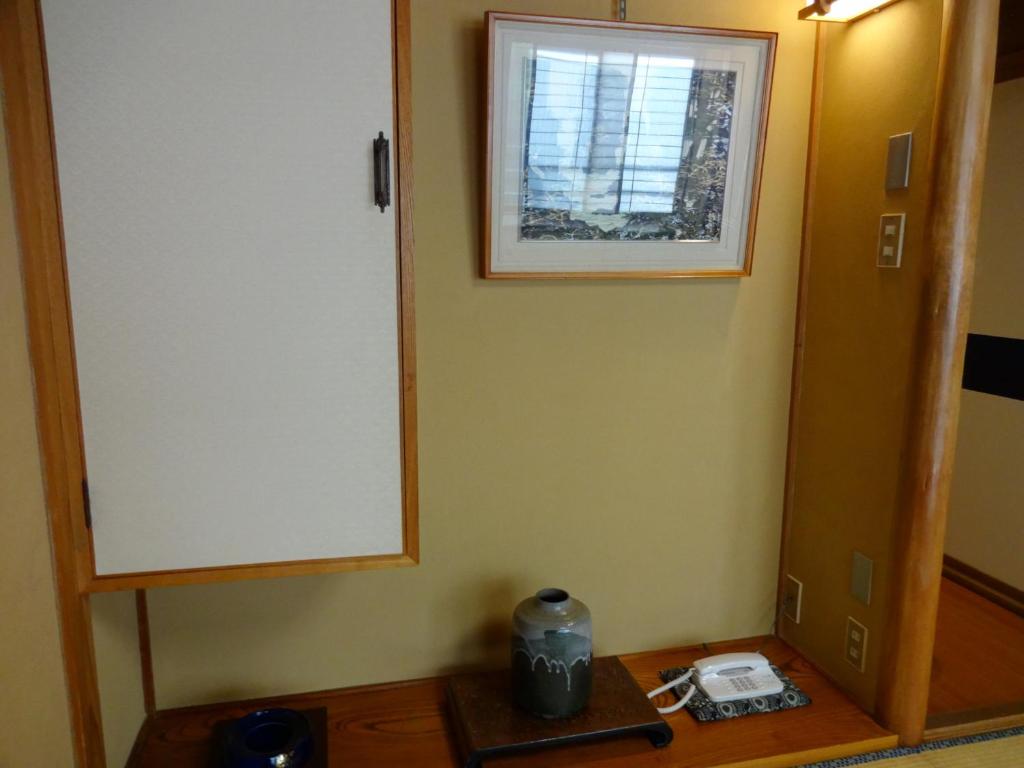 a mirror sitting on a table in a room at Jizokan Matsuya Ryokan in Nagano