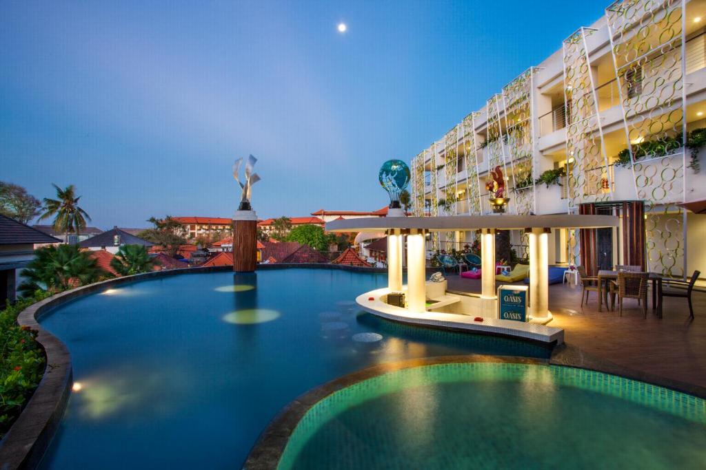 a swimming pool in front of a hotel at Ion Bali Benoa in Nusa Dua