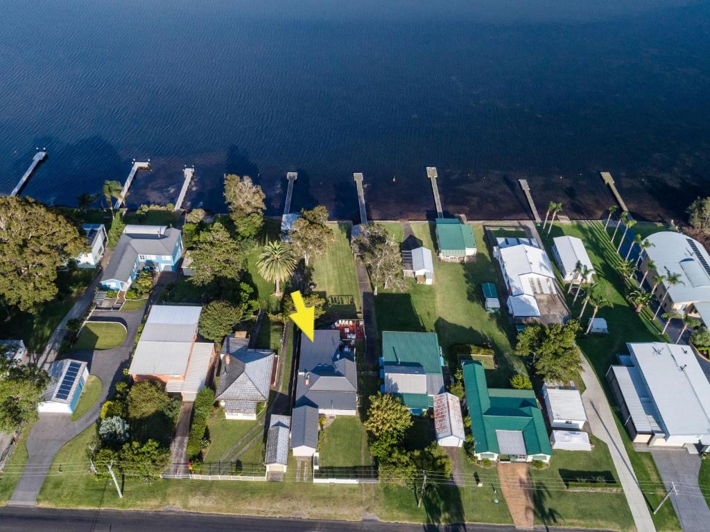 an aerial view of a house next to the water at On Golden Ponds at Erowal Bay in Erowal Bay