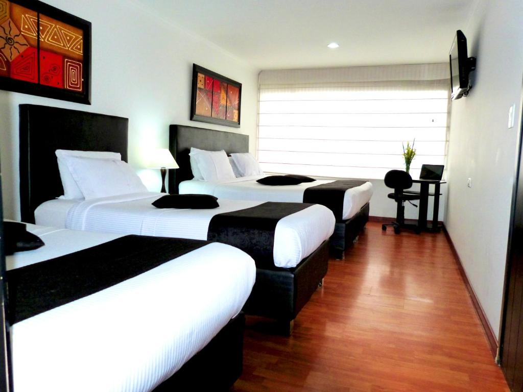 Postel nebo postele na pokoji v ubytování Hotel Radel Bogotá