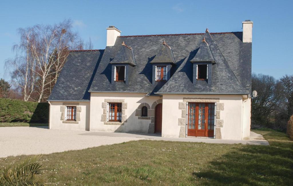 a house with a gray roof and red doors at 4 Bedroom Amazing Home In Pleubian in Pleubian
