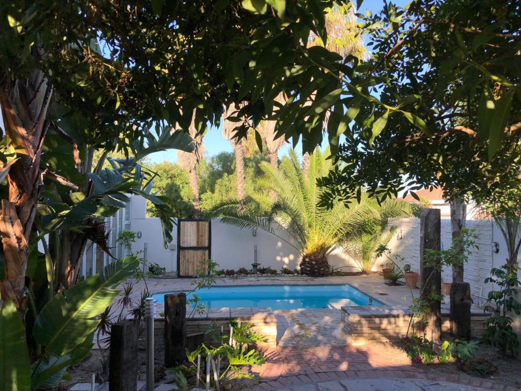 a pool in the backyard of a house with trees at Old Cape on the Marina - De Pond : Unit 6 in Velddrif