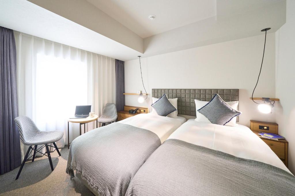 Postel nebo postele na pokoji v ubytování Hotel Resol Stay Akihabara