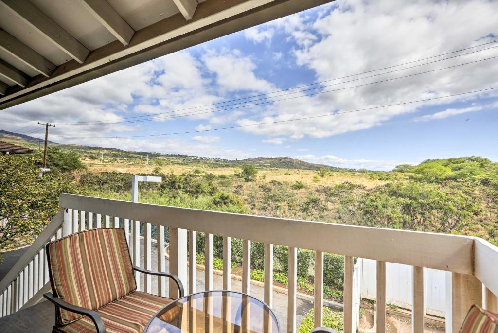 a balcony with a chair and a view of a hill at Kapolei Condo with Lanai and Pool Access - Near Beach! in Kapolei