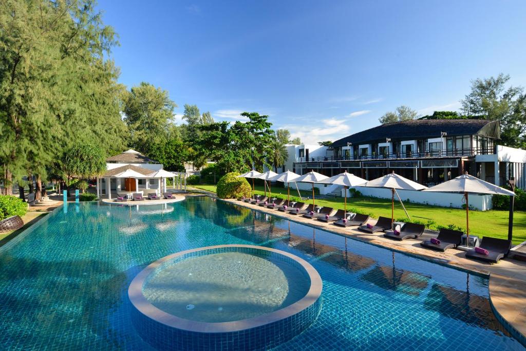 a swimming pool with a pool table and chairs at Twin Lotus Resort and Spa - SHA Plus in Ko Lanta