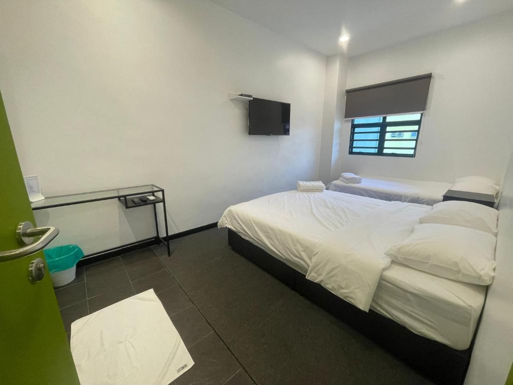 Postel nebo postele na pokoji v ubytování Olive Bedz Hotel