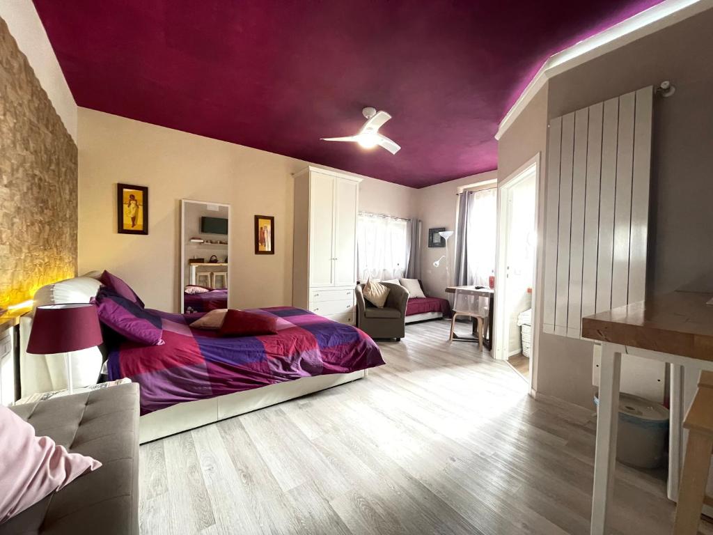 a bedroom with a bed and a purple ceiling at Le Rosette Assisi in Cannara