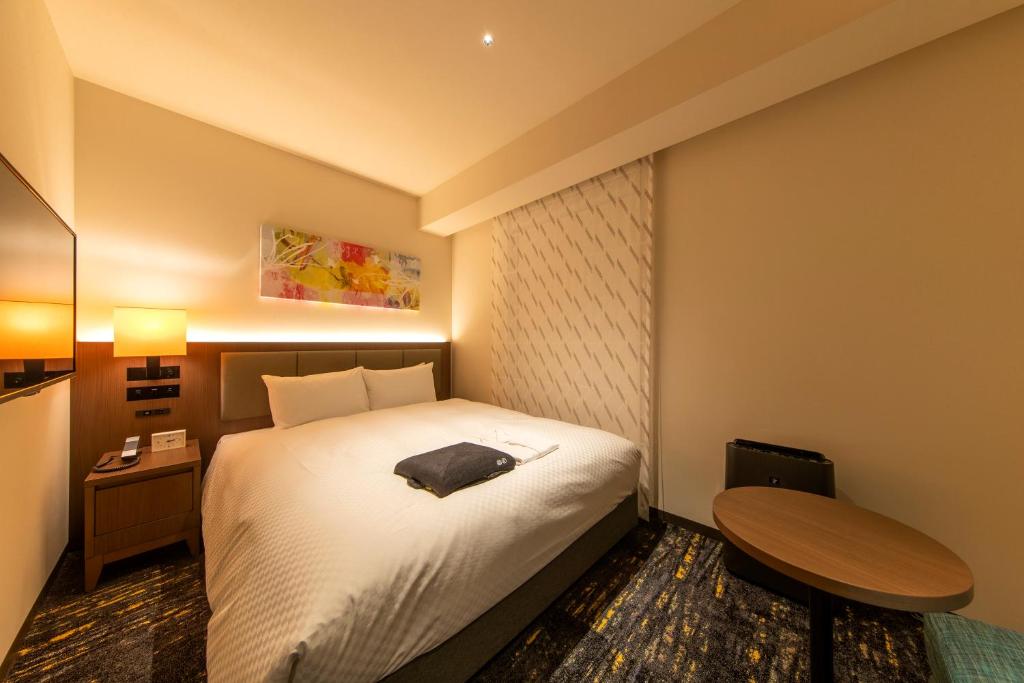 Postel nebo postele na pokoji v ubytování Hotel Forza Nagoya Sakae