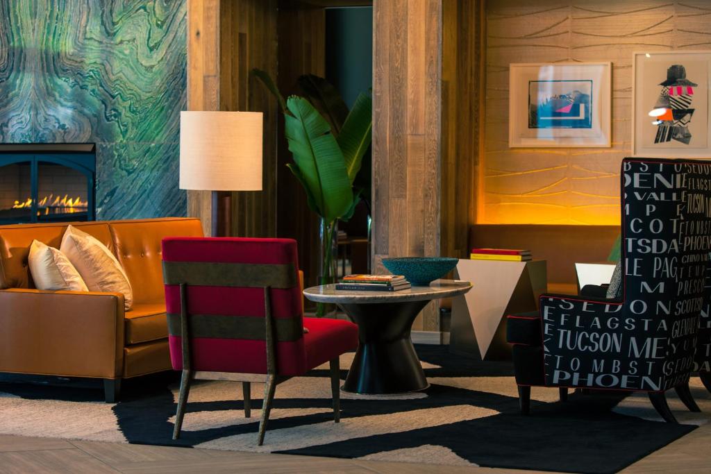 a living room with a couch and a table and chairs at Kimpton Hotel Palomar Phoenix Cityscape, an IHG Hotel in Phoenix