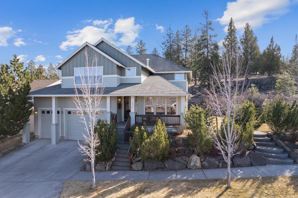 a house with a driveway and trees at Flagline Trail home in Bend