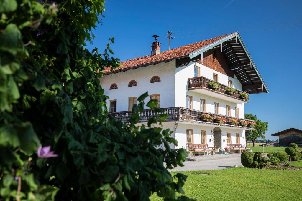 a large white building with a balcony on top of it at Naderbauer-Hof in Marquartstein