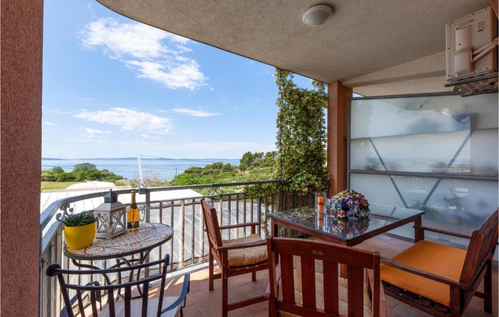 a balcony with tables and chairs and a view of the ocean at Stunning Apartment In Split With 2 Bedrooms And Wifi in Split