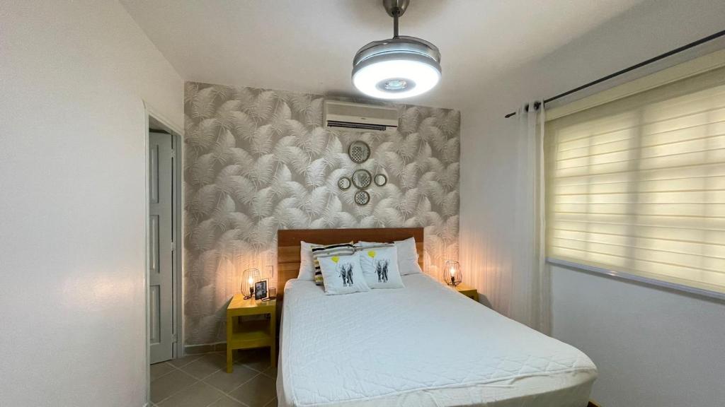 a bedroom with a bed with two pillows on it at Playa Turquesa only 50m From the Beach Walk to all Restaurants in Las Terrenas