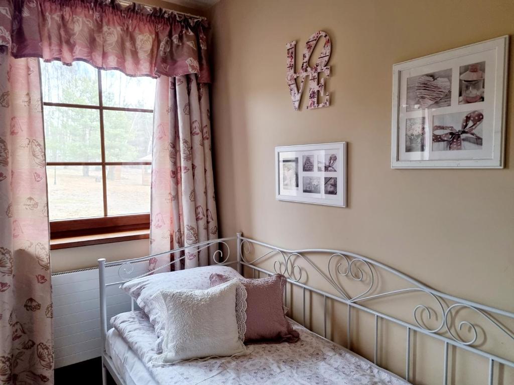 a bedroom with a bed and a window at Zacisze Jurajskie in Olsztyn