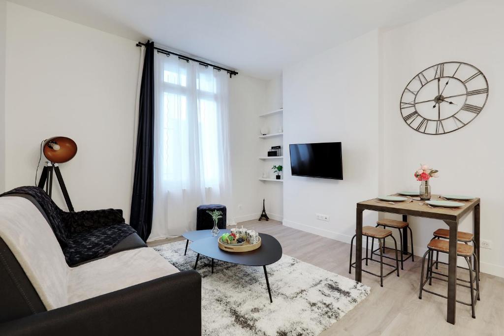 a living room with a couch and a table at CMG Charmant appartement 1BR/4P - République / Temple in Paris