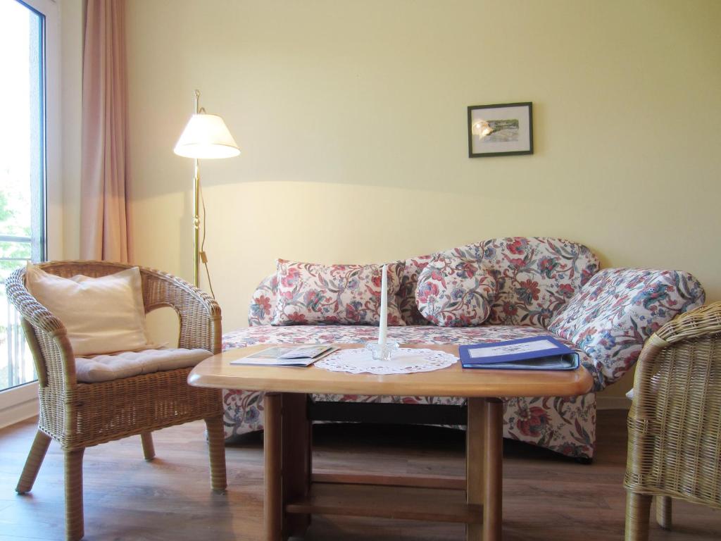 a living room with a couch and a table with a candle at Ferienwohnung Marianne in Fulgen