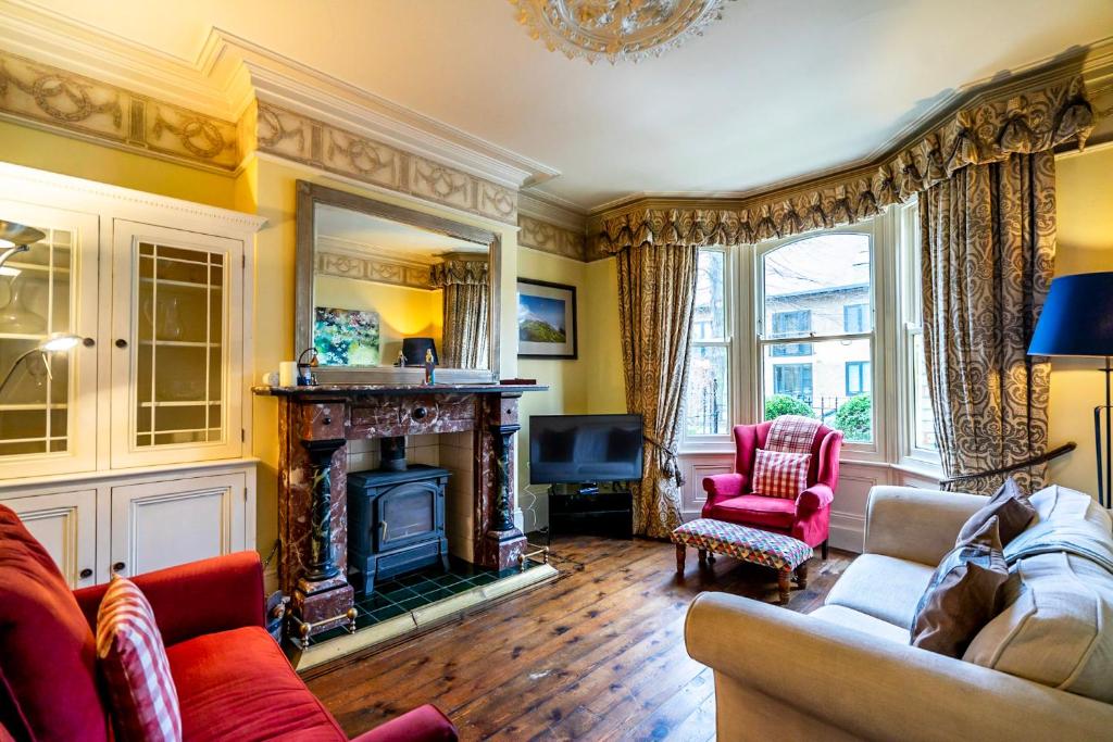 a living room with a couch and a fireplace at 7 St John's Crescent in York