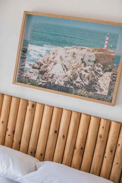 a picture of the ocean above a bed at MUTE Hostel Porto Covo in Porto Covo