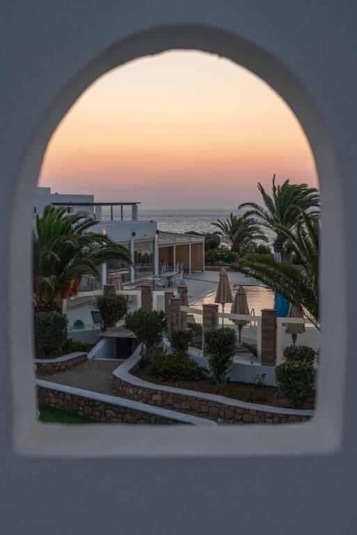 a view of the beach from an archway of a resort at Irini Hotel in Afiartis